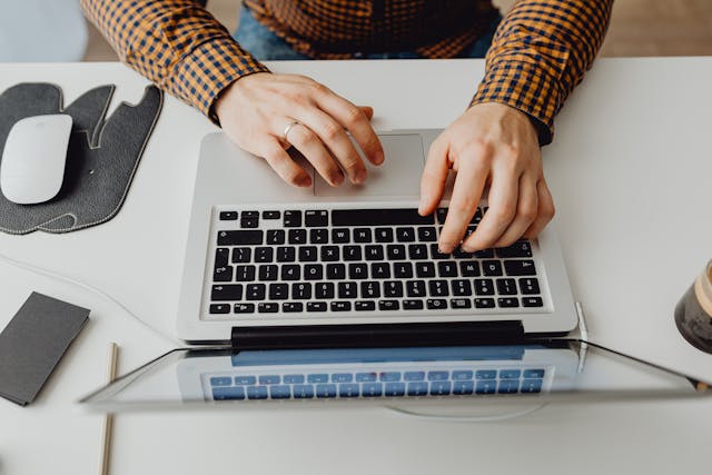a person typing on a laptop